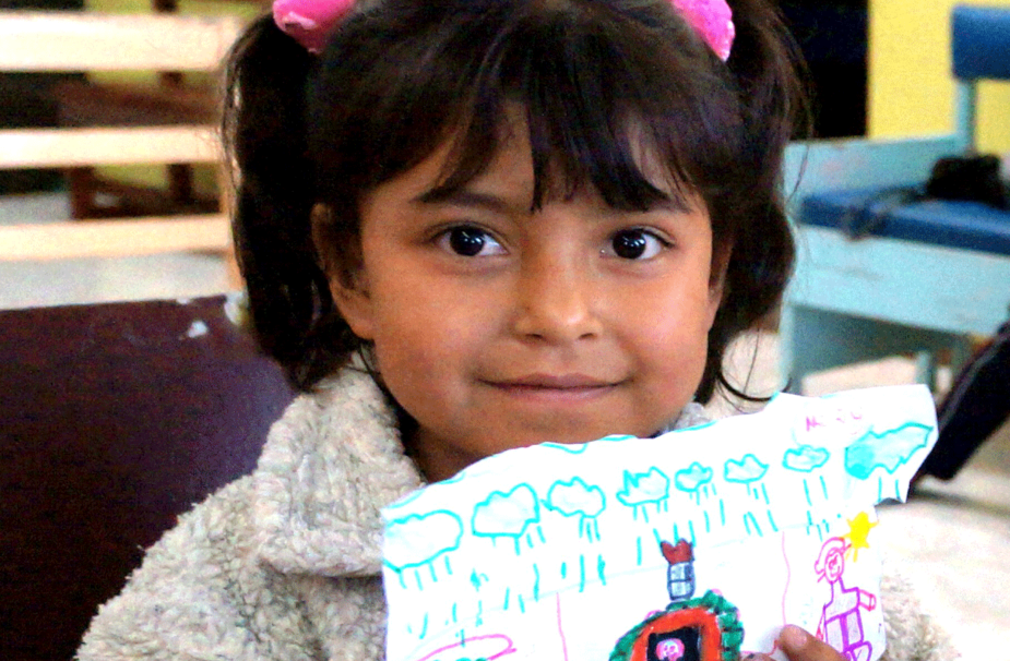 A columbian godgirl proudly 
shows a drawing